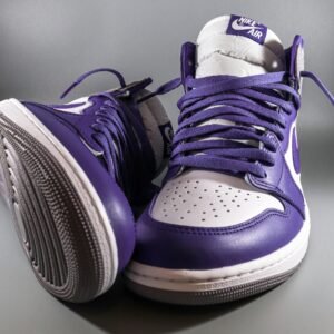A close-up studio shot of purple and white Nike Air Jordan sneakers featuring stylish design.
